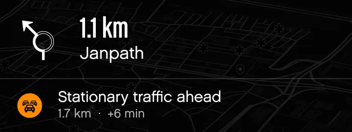 A turn card with a stationary traffic alert: 1.7 km ahead, plus 6 minutes